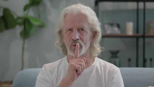 Silence Please Gesture by Old Man at Home