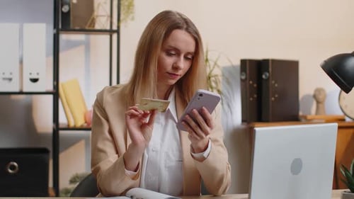 Businesswoman Making Online Purchase Payment Shopping with Credit Bank Card and Smartphone at Office