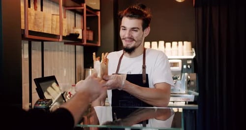 Barista Serving a Customer Food Order at Counter