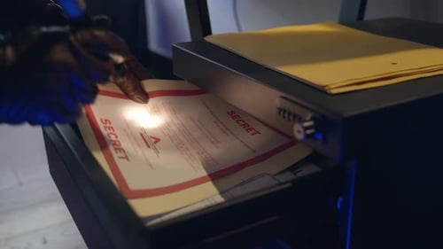 Gloves Hands Examine Confidential Files in Office