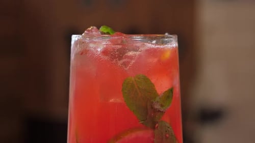 Closeup of Refreshing Berry Lemonade with Mint Lemon Slices and Ice on the Bar