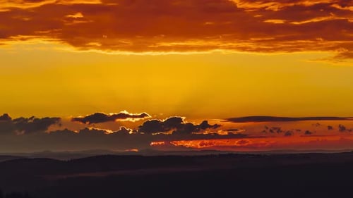 Golden Horizon Breathtaking Sunset Clouds Over A Peaceful Mountain Silhouette