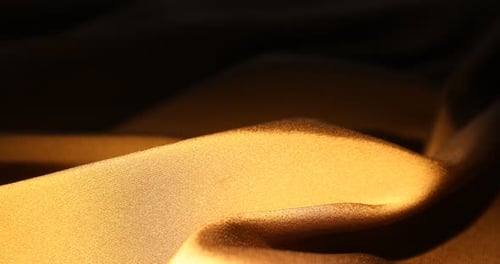 Abstract golden fabric background with light movement
