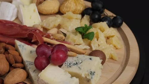Assorted Cheeses, Meats, and Fruits on Charcuterie Board
