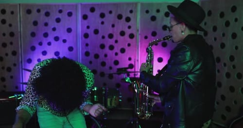 Young musicians dancing while mixing new album inside recording studio