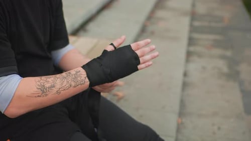 Man Wrapping His Hands With Boxing Wraps