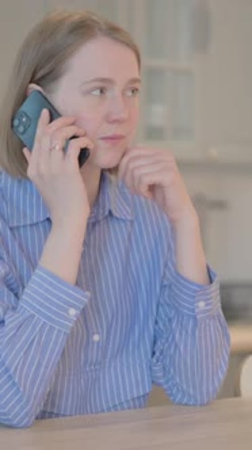Woman in Striped Shirt on Mobile Phone Call