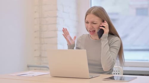Angry Young Woman Talking on a Smartphone