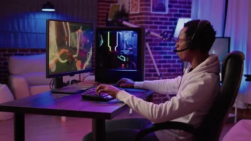Gamer Plays Video Game on Computer at Night