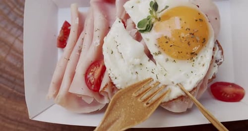 Breakfast Sandwich Being Cut With a Small Fork