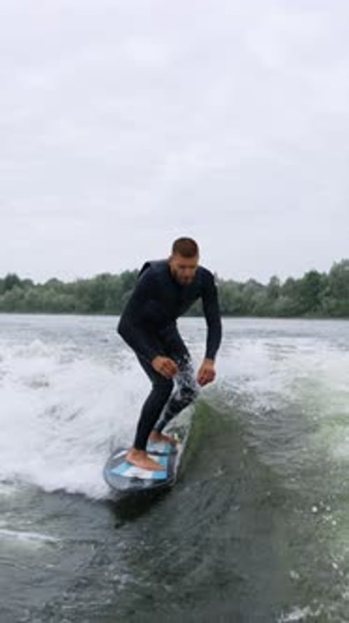 A Talented Surfer Demonstrates His Skills on the Water Skillfully Navigating Waves with Precision
