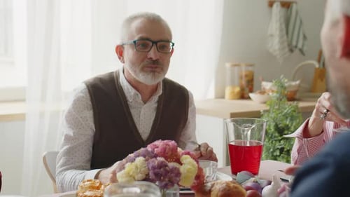 Adults Eating Together Around a Table