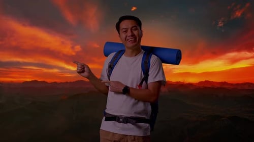 Asian Male Smiling And Pointing To Side On Top Mountain