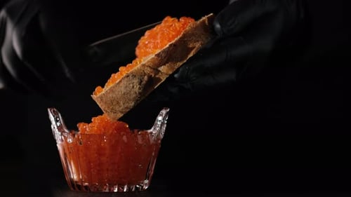 Chef Preparing Red Caviar on Bread