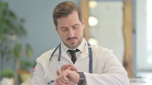 Portrait of Male Doctor Using Smart watch