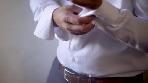 Man Fastening Cufflinks on Sleeves in Close Up Shot
