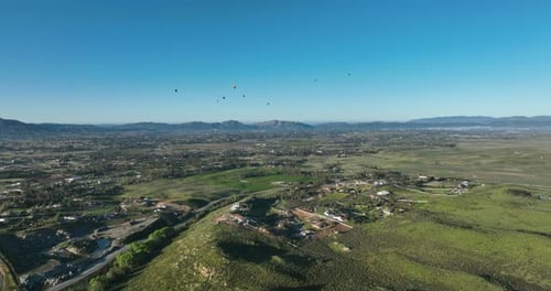 Aerial View of Green Landscape With Hot Air Balloons