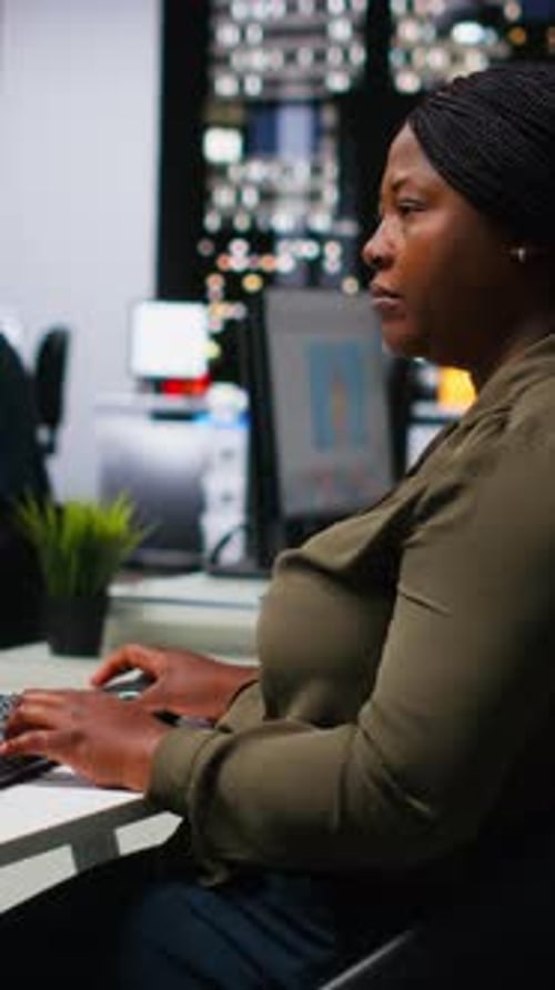Woman Works on Computer at Desk in Office