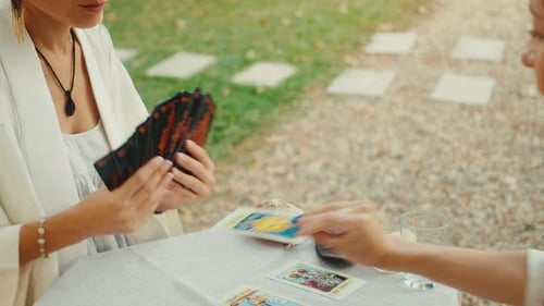 Women Enjoying a Tarot Card Reading in Garden