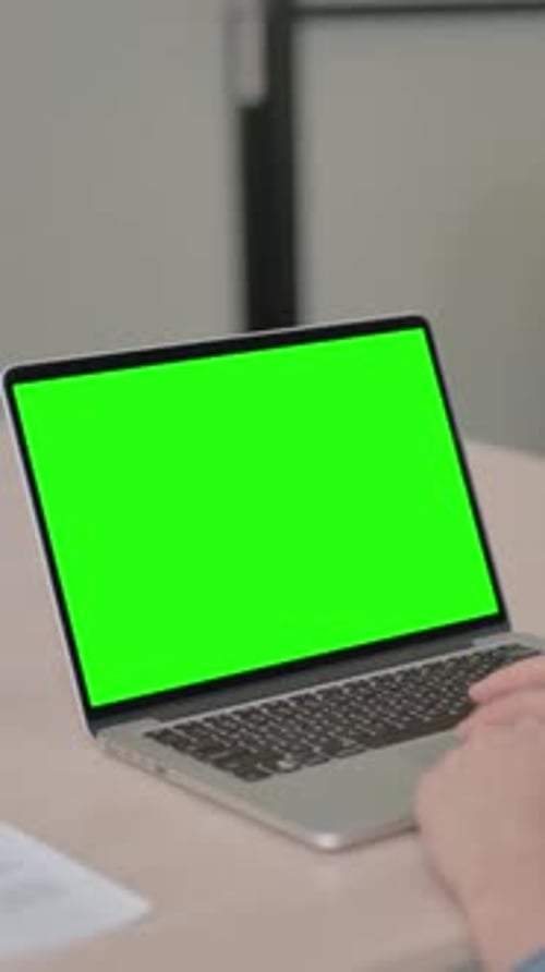 Young Woman Using Laptop with Green Screen, Vertical Video