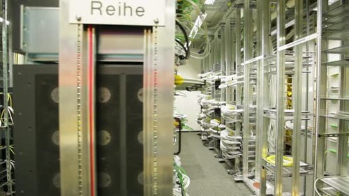 Dolly shot of server racks and network cables