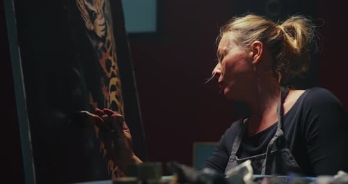 Woman Painting Tiger on Easel