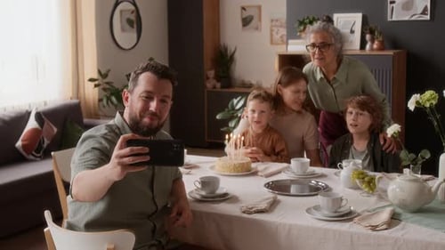 Multi-generational family celebrate birthday at home