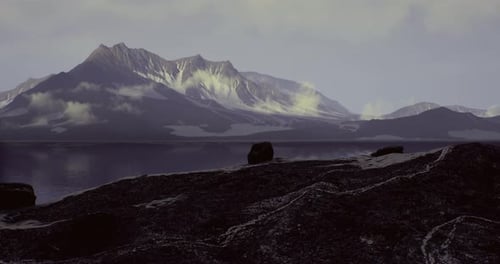 Stunning Panoramic View of Mountain Range Reflecting on the Calm Lake at Dusk
