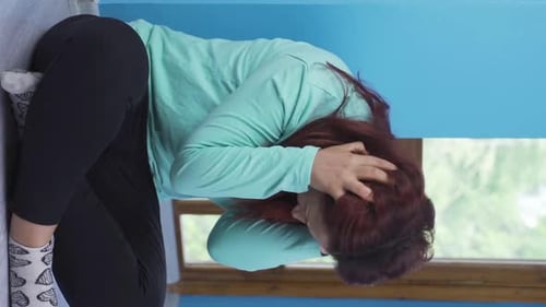 Woman in Distress Sitting on the Floor