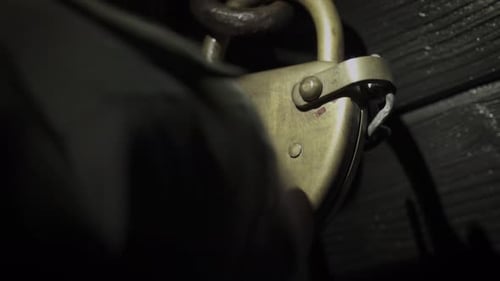 Hand Opening Door With Vintage Padlock At Night. Norwegian Trekking Association. - closeup shot