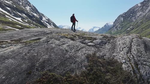Person Standing on Top of Large Rock in Vestland County, Norway