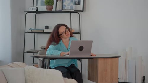 Annoyed Businenesswoman Works with Documents