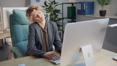 Woman Working At Desk Gets Stiff and Stretches