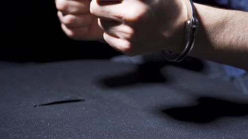 Adult's Hands Cuffed During Interrogation