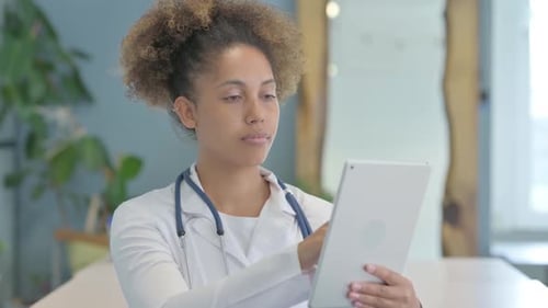 Female African Doctor using Tablet in Clinic