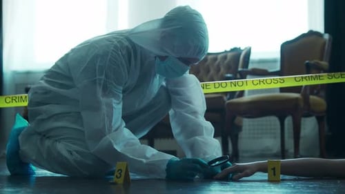 Person Examines Evidence at Crime Scene