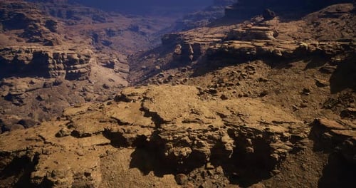 Stunning Rocky Landscape with Deep Canyons in Arid Terrain During Midday Sun