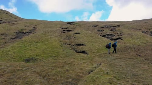 Aerial view of hikers on mountain, Faroe Islands.