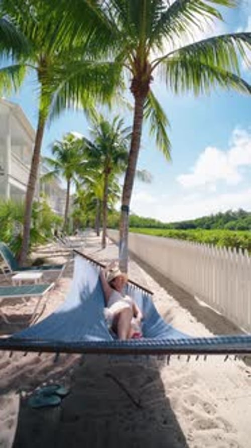 Woman Relaxing in Hammock on Tropical Beach