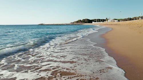 Dolly Shot on Little Waves on Sand Beach