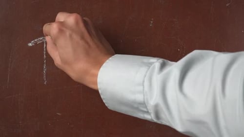 Writing the Word Thanks on a Brown Surface