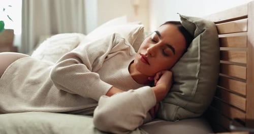 Woman Relaxing Peacefully Asleep in Bed