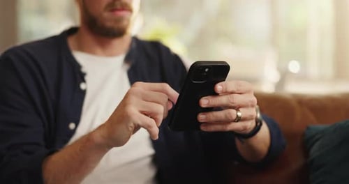 Adult Using Cellphone Indoors on Couch