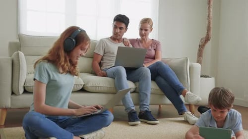 Family Relaxing with Technology in Bright Home