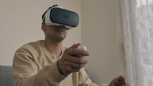 Young Adult Gaming with Virtual Reality Headset at Home
