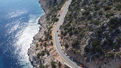 Aerial View of Coastal Road Winding Along Steep Cliff beside Deep Blue Sea near Kas