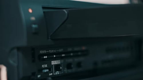 Insert VHS Cassette Into VCR Video Player