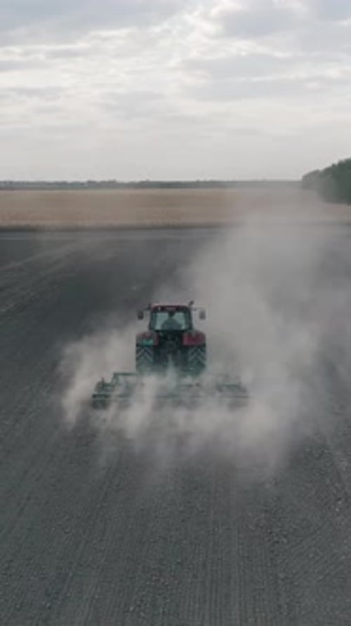 Tractor Plowing Field Slow Motion Aerial Vertical Shot