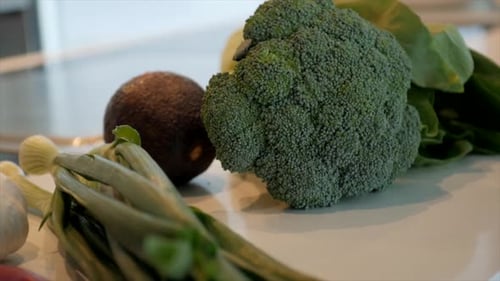 4k camera footage. Different and colorful vegetables. Eating healthy at home. Garlic, broccoli, avoc