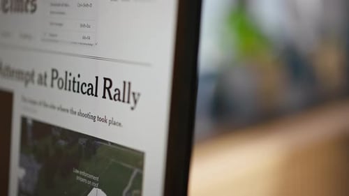 News Article about Shooting at Political Rally on Screen